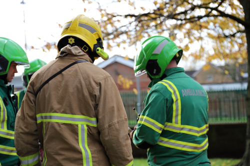 A firefighter speaking to members of North West Ambulance Service's Hazardous Response Team