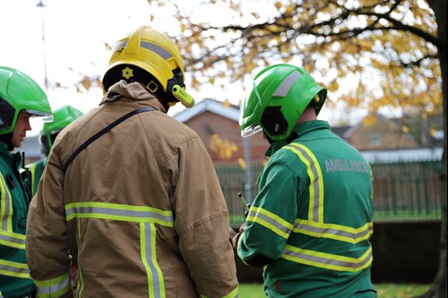 A firefighter speaking to members of North West Ambulance Service's Hazardous Response Team