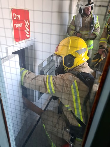 Firefighters wearing breathing apparatus using a dry riser during a high rise training exercise in Kirkby.